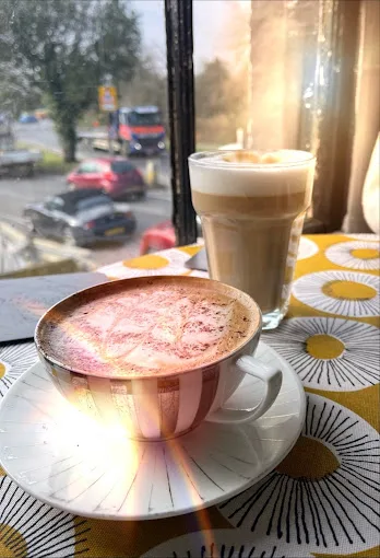 A latte and cappuccino with latte art at Dennie's Cafe