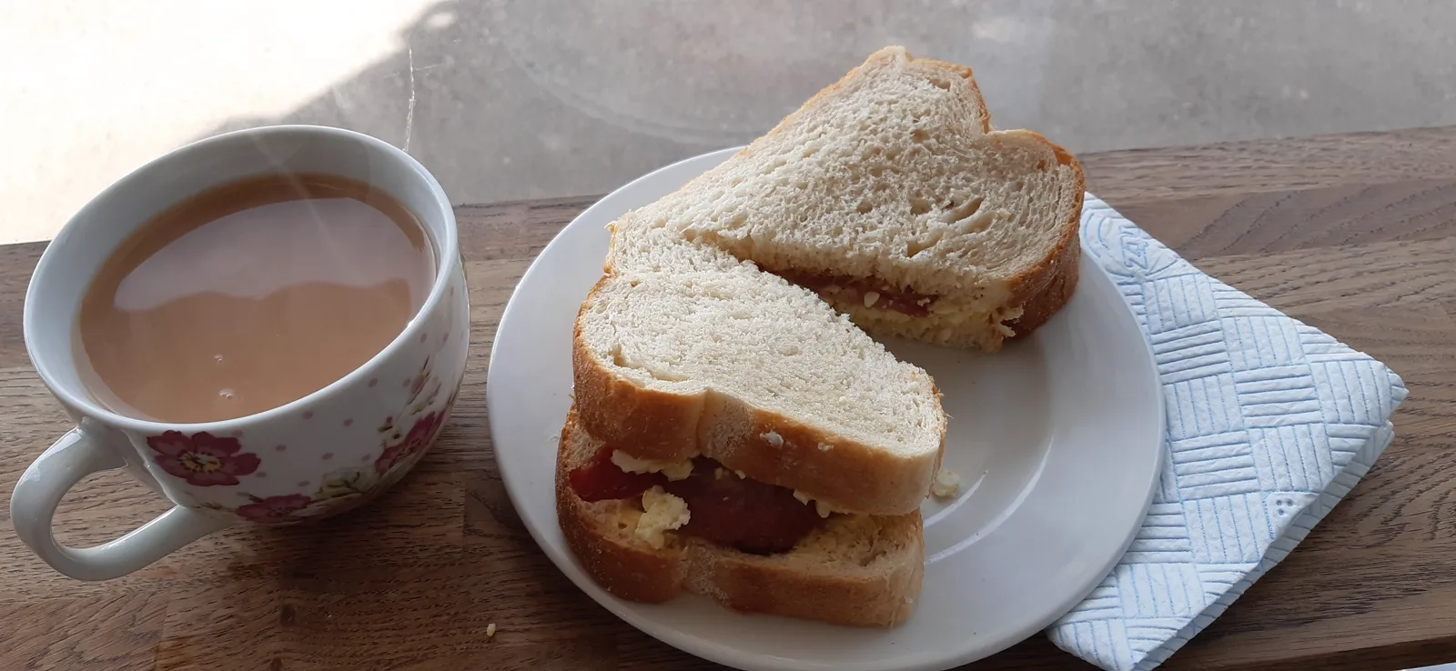 A freshly made sandwich served with a pot of tea at Dennie's Cafe
