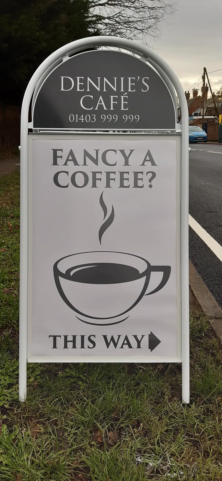 The pavement sign for Dennie's Cafe